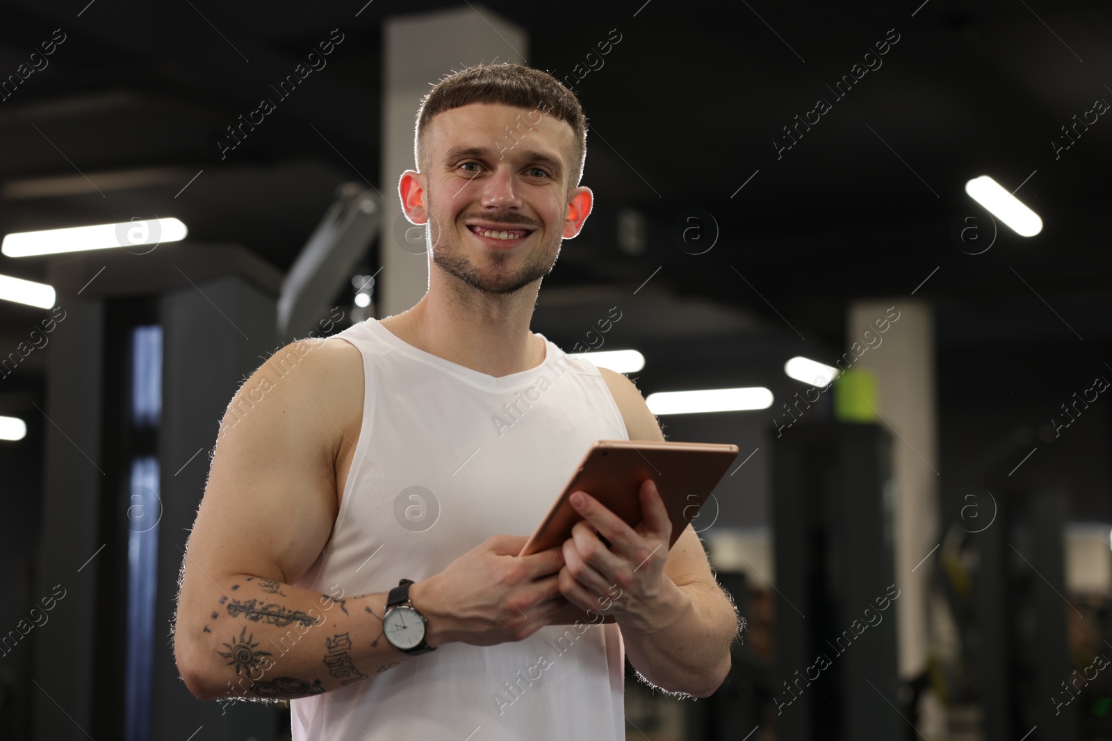 Personal trainer with tablet in sport center Photo of Personal trainer with tablet in sport center