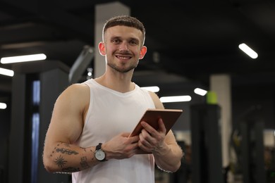 Photo of Personal trainer with tablet in sport center
