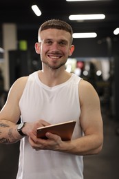 Photo of Personal trainer with tablet in sport center