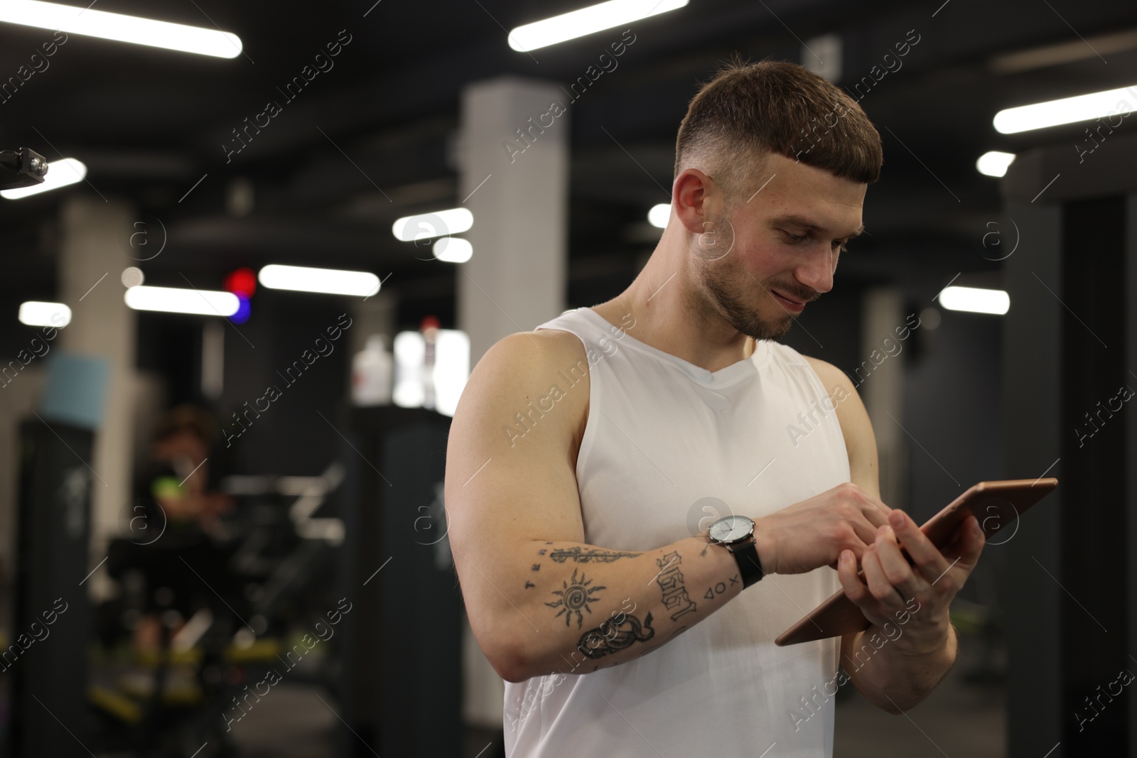 Personal trainer with tablet in sport center. Space for text Photo of Personal trainer with tablet in sport center. Space for text