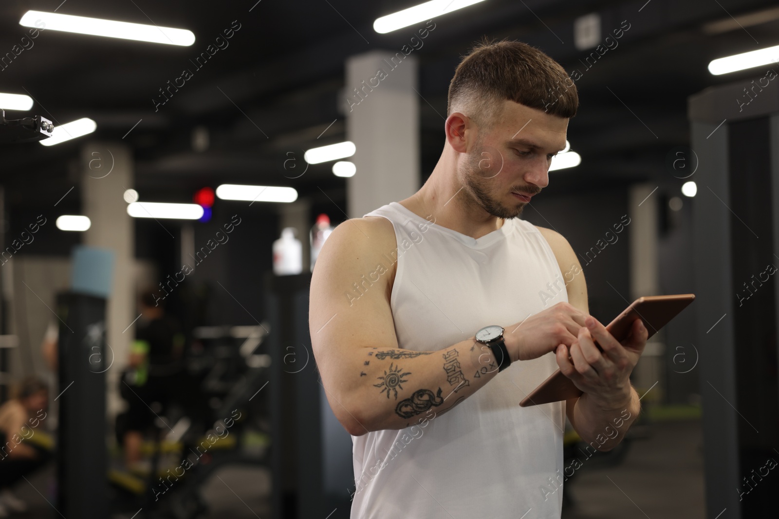Personal trainer with tablet in sport center. Space for text Photo of Personal trainer with tablet in sport center. Space for text