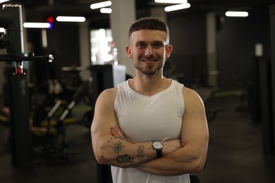 Photo of Portrait of professional personal trainer in gym