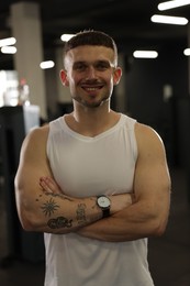 Photo of Portrait of professional personal trainer in gym