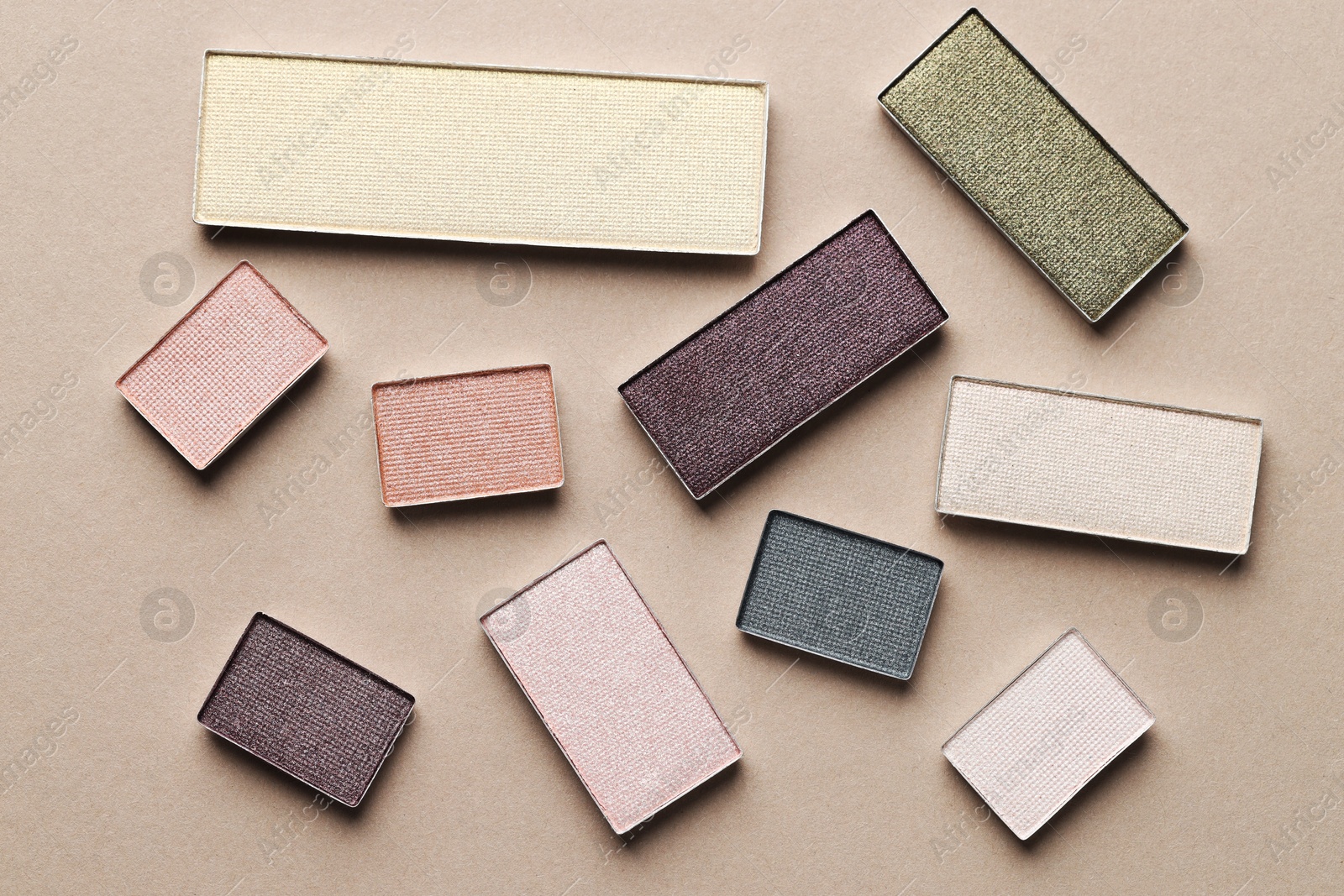 Beautiful eyeshadow refill pans on beige background, flat lay Photo of Beautiful eyeshadow refill pans on beige background, flat lay