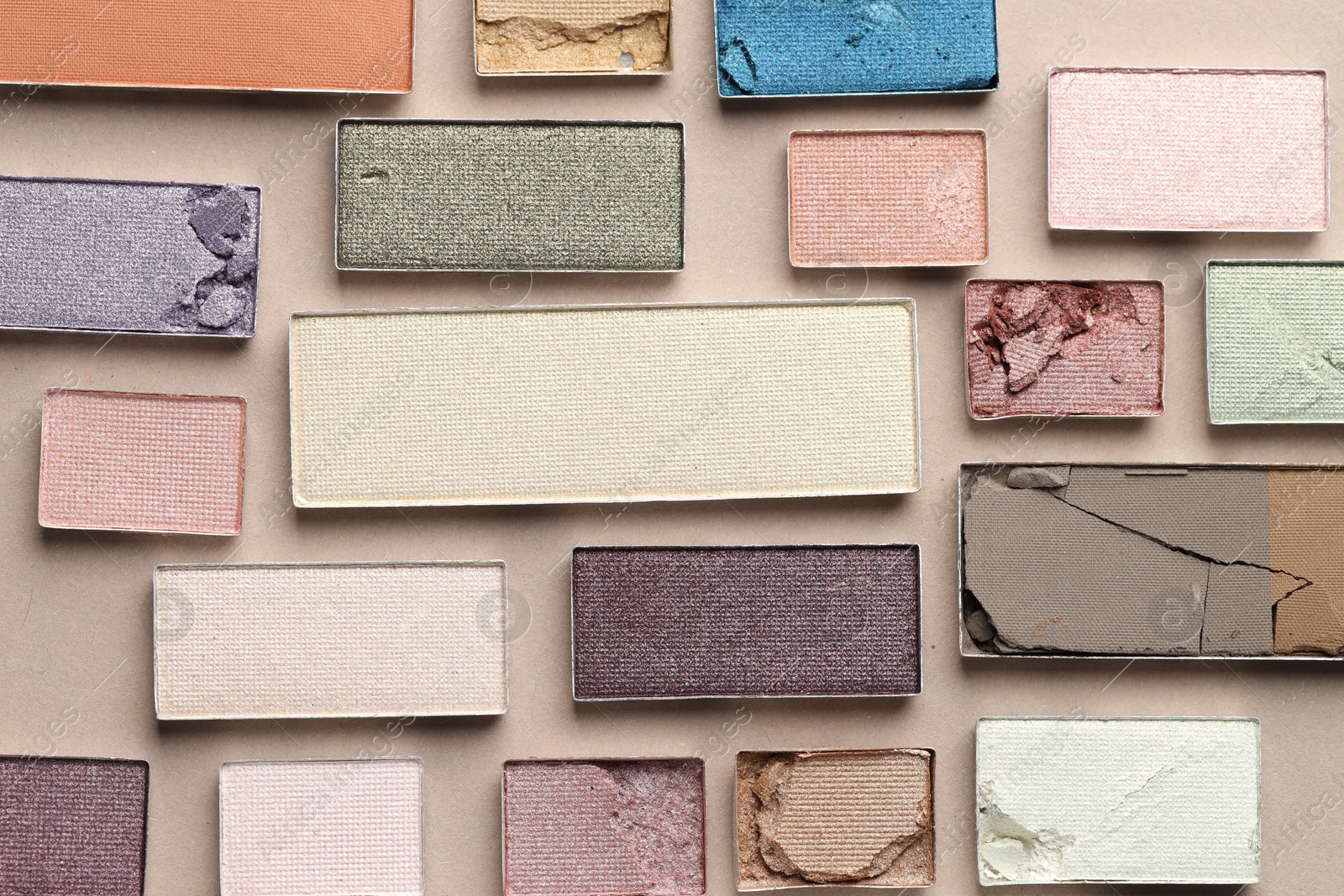 Beautiful eyeshadow refill pans on beige background, flat lay Photo of Beautiful eyeshadow refill pans on beige background, flat lay