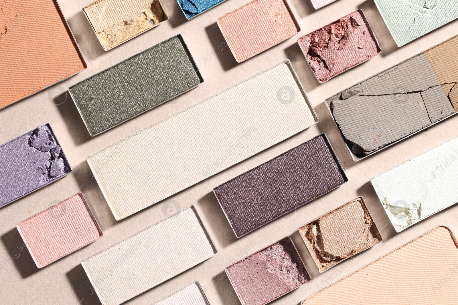 Beautiful eyeshadow refill pans on beige background, flat lay Photo of Beautiful eyeshadow refill pans on beige background, flat lay