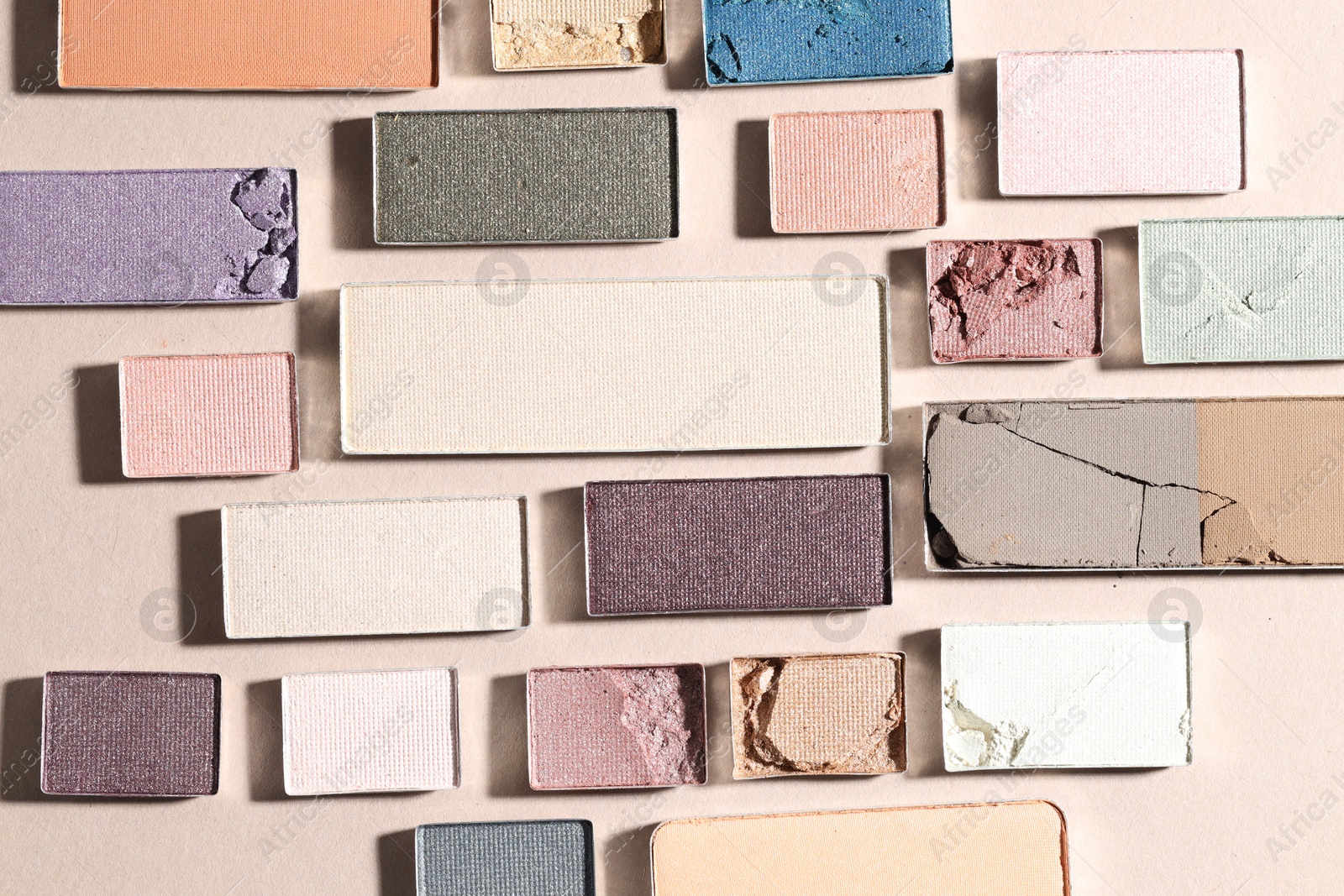 Beautiful eyeshadow refill pans on beige background, flat lay Photo of Beautiful eyeshadow refill pans on beige background, flat lay