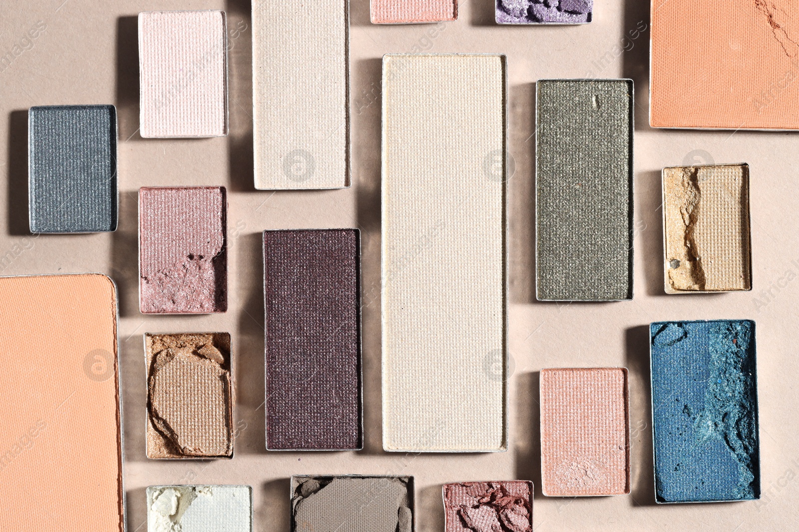 Beautiful eyeshadow refill pans on beige background, flat lay Photo of Beautiful eyeshadow refill pans on beige background, flat lay