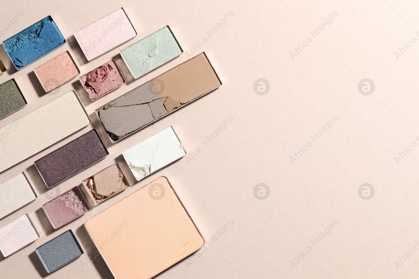 Beautiful eyeshadow refill pans on beige background, flat lay. Space for text Photo of Beautiful eyeshadow refill pans on beige background, flat lay. Space for text