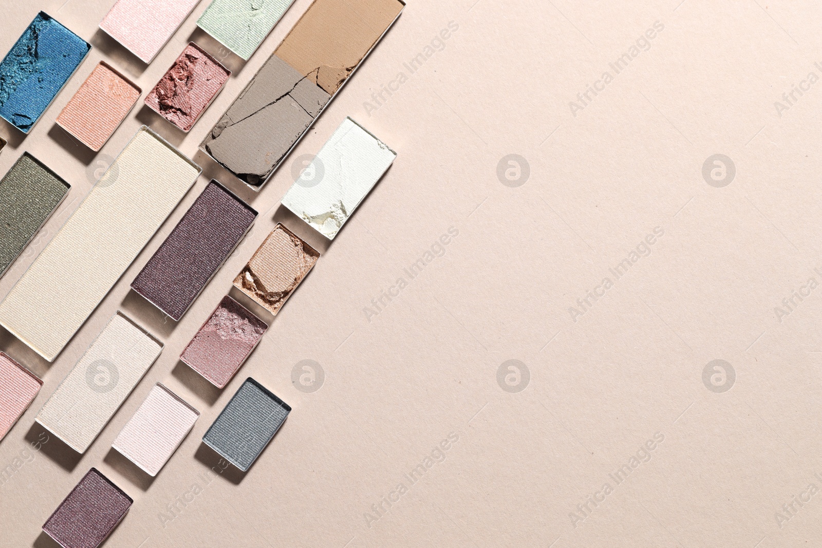 Beautiful eyeshadow refill pans on beige background, flat lay. Space for text Photo of Beautiful eyeshadow refill pans on beige background, flat lay. Space for text