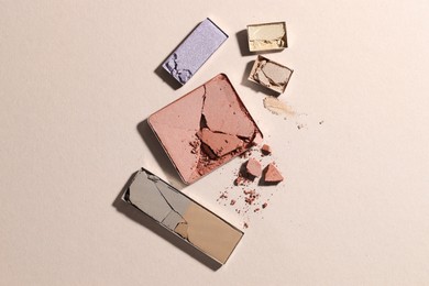Photo of Beautiful eyeshadow refill pans on beige background, flat lay