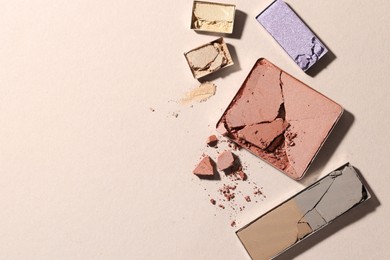 Photo of Beautiful eyeshadow refill pans on beige background, flat lay. Space for text