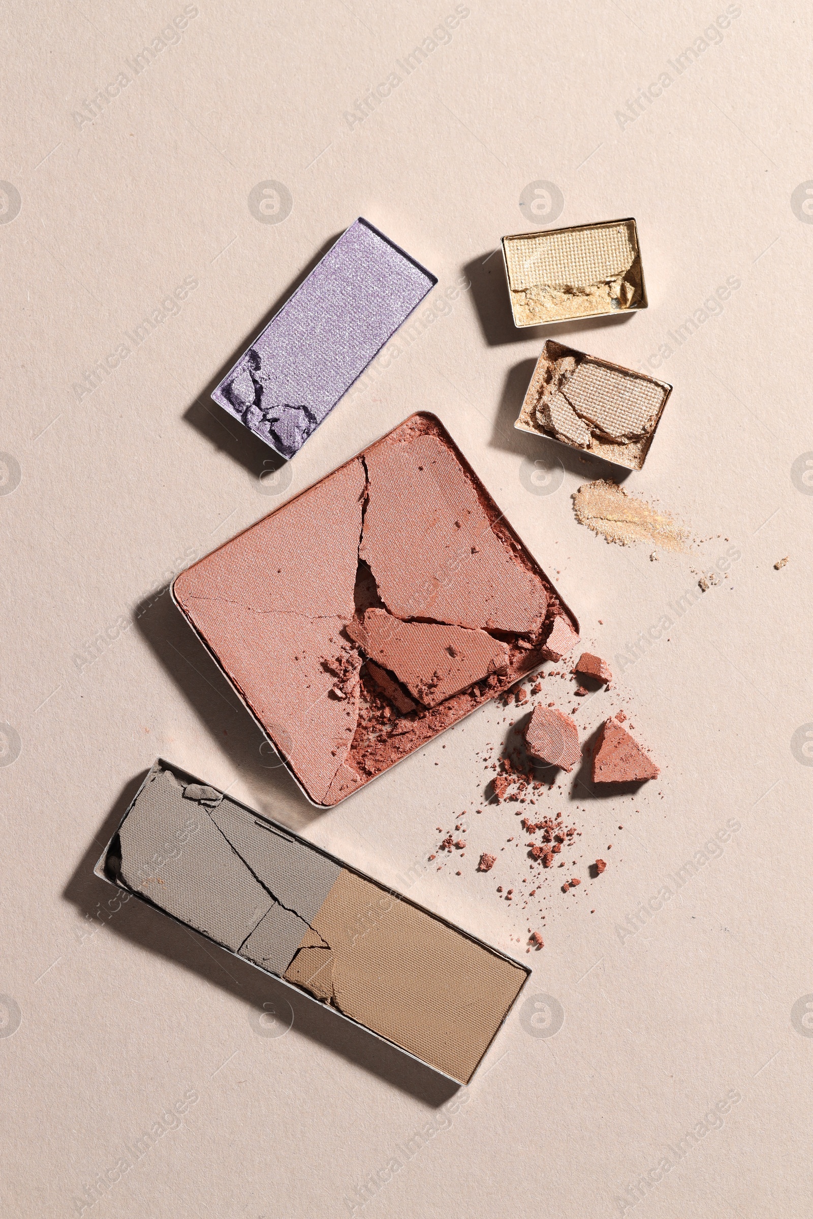 Beautiful eyeshadow refill pans on beige background, flat lay Photo of Beautiful eyeshadow refill pans on beige background, flat lay
