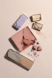 Photo of Beautiful eyeshadow refill pans on beige background, flat lay