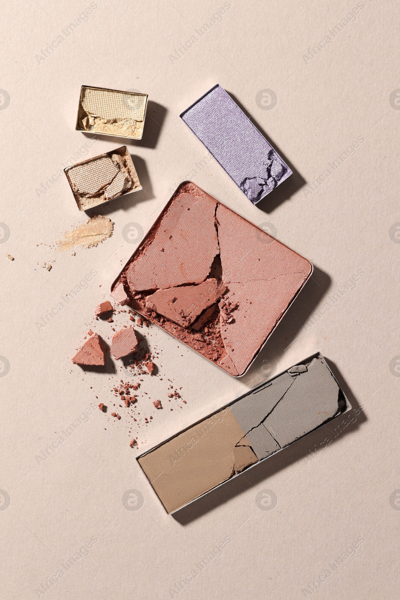 Beautiful eyeshadow refill pans on beige background, flat lay Photo of Beautiful eyeshadow refill pans on beige background, flat lay