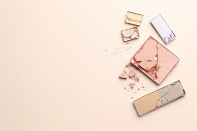 Photo of Beautiful eyeshadow refill pans on beige background, flat lay. Space for text