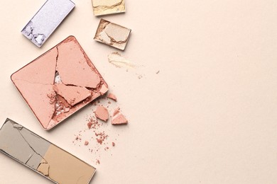 Photo of Beautiful eyeshadow refill pans on beige background, flat lay. Space for text