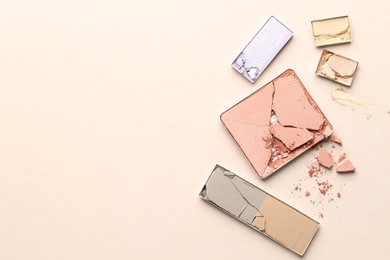 Photo of Beautiful eyeshadow refill pans on beige background, flat lay. Space for text