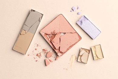 Photo of Beautiful eyeshadow refill pans on beige background, flat lay