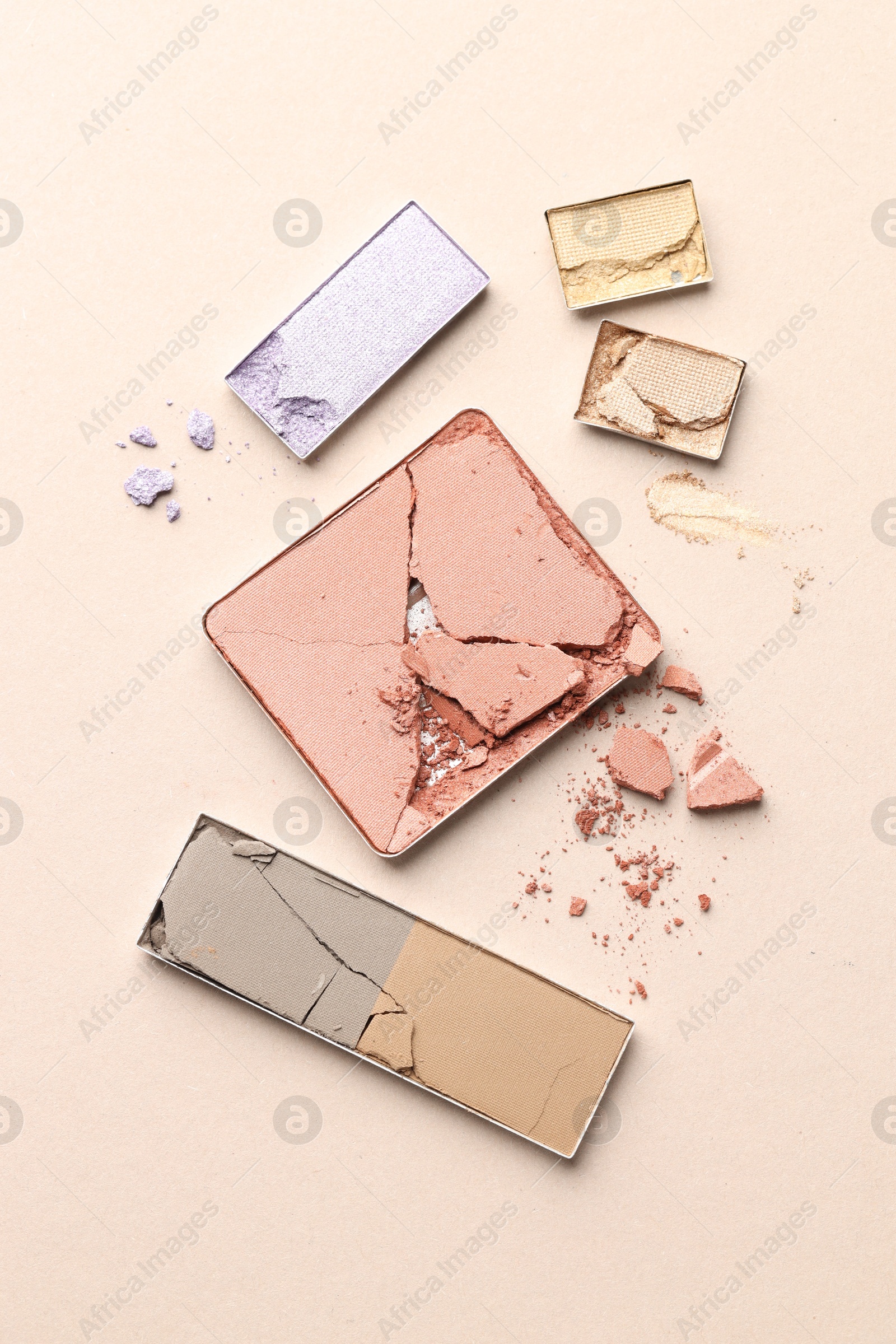 Beautiful eyeshadow refill pans on beige background, flat lay Photo of Beautiful eyeshadow refill pans on beige background, flat lay