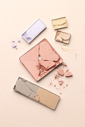 Photo of Beautiful eyeshadow refill pans on beige background, flat lay
