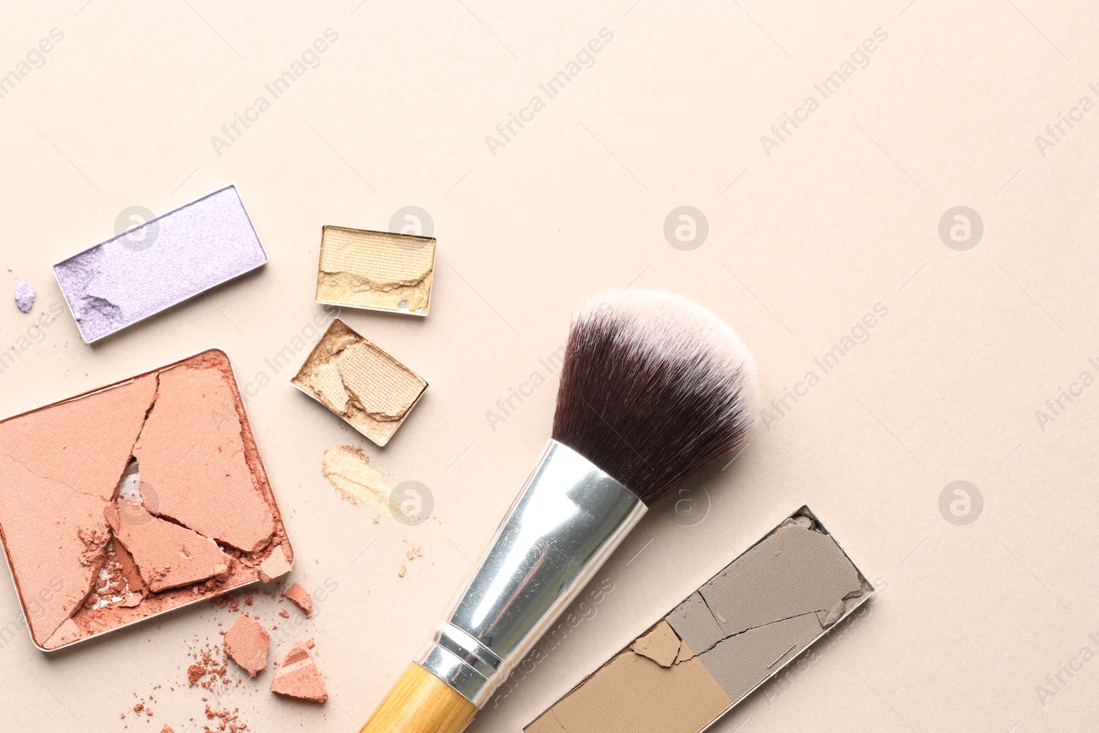 Beautiful eyeshadow refill pans and brush on beige background, flat lay. Space for text Photo of Beautiful eyeshadow refill pans and brush on beige background, flat lay. Space for text