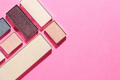 Photo of Beautiful eyeshadow refill pans on pink background, flat lay. Space for text