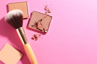 Photo of Refill pans of cosmetic products and brush on pink background, flat lay. Space for text