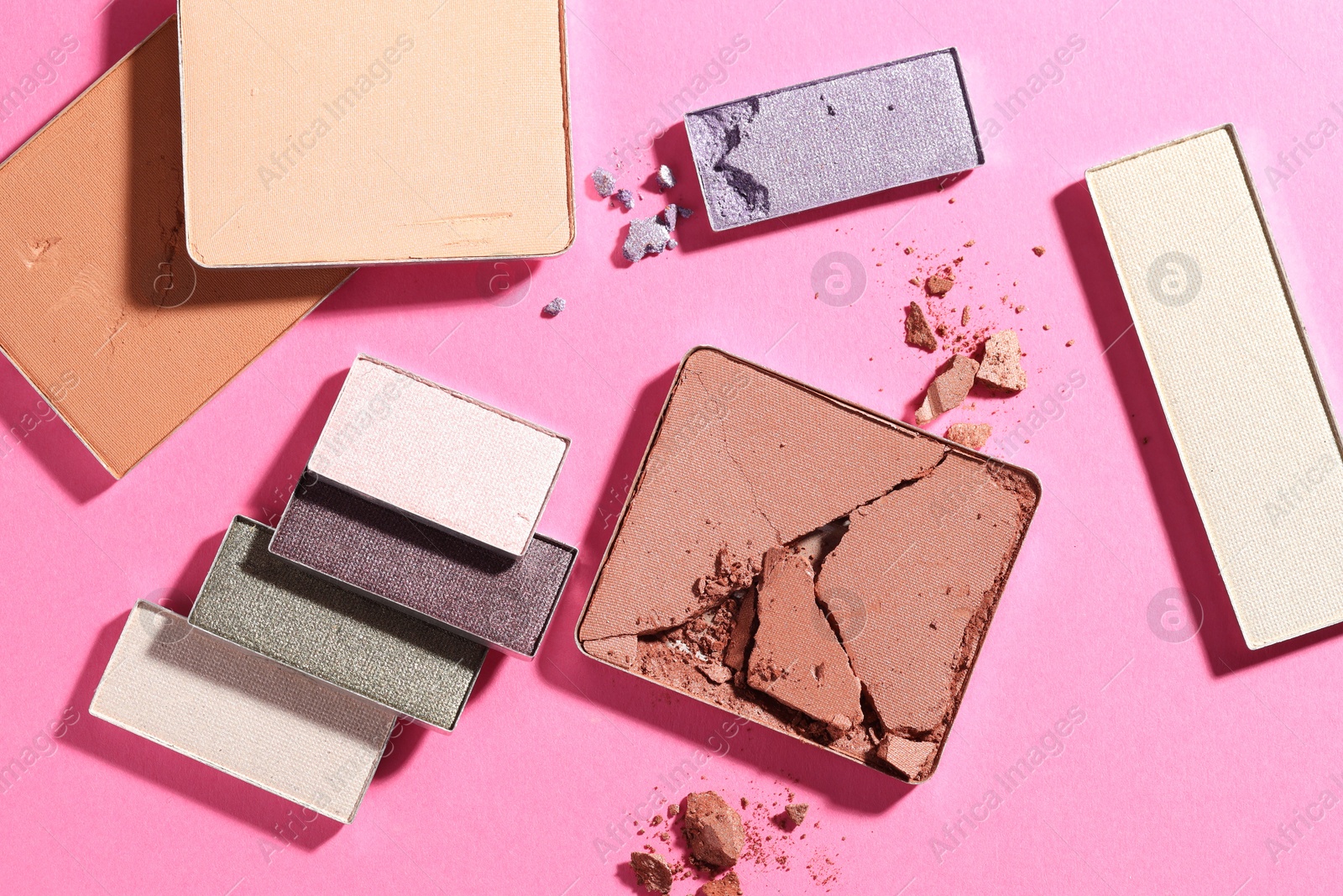 Beautiful eyeshadow refill pans on pink background, flat lay Photo of Beautiful eyeshadow refill pans on pink background, flat lay