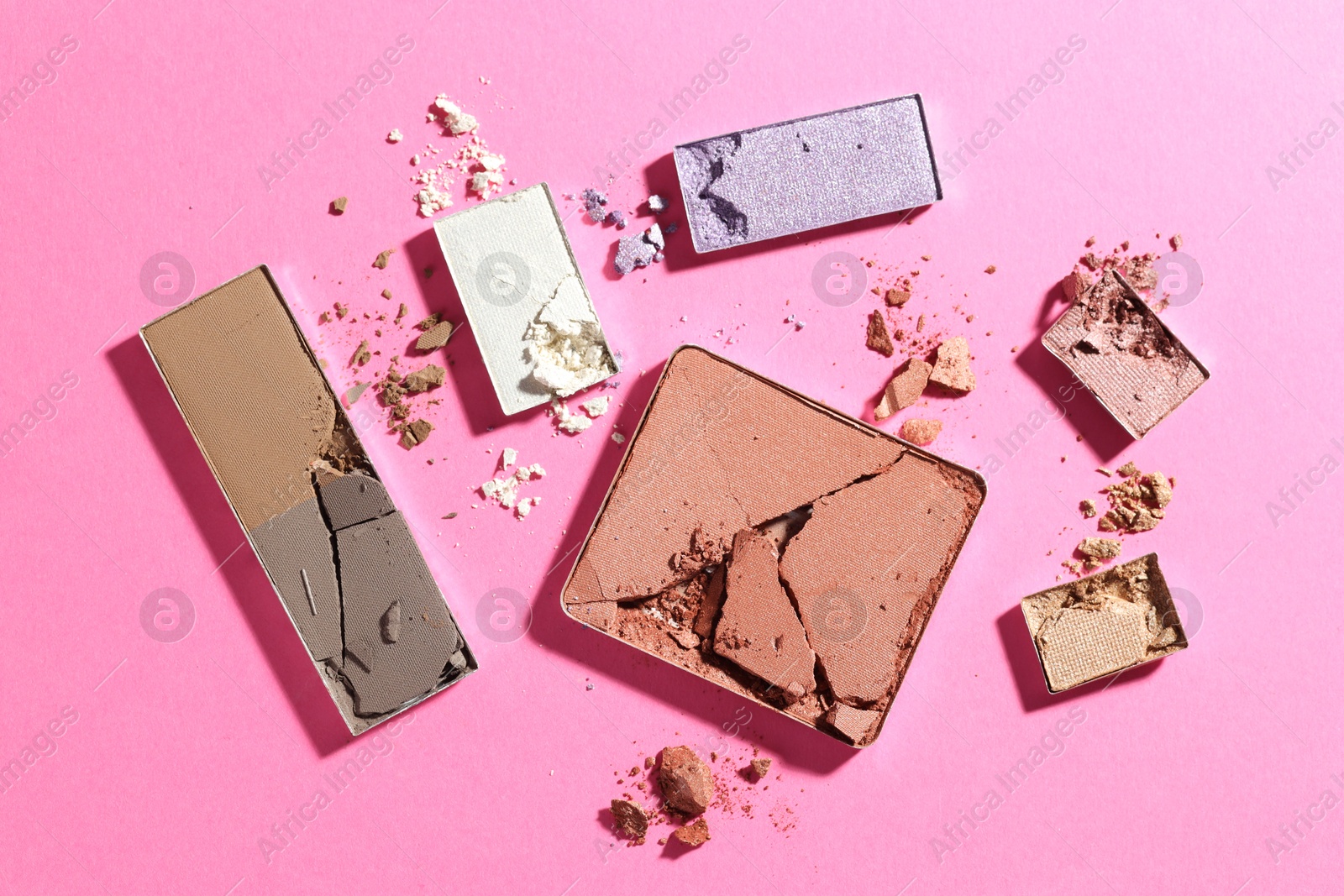Beautiful eyeshadow refill pans on pink background, flat lay Photo of Beautiful eyeshadow refill pans on pink background, flat lay