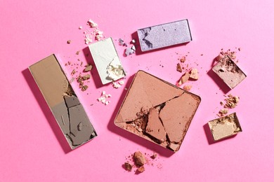 Photo of Beautiful eyeshadow refill pans on pink background, flat lay