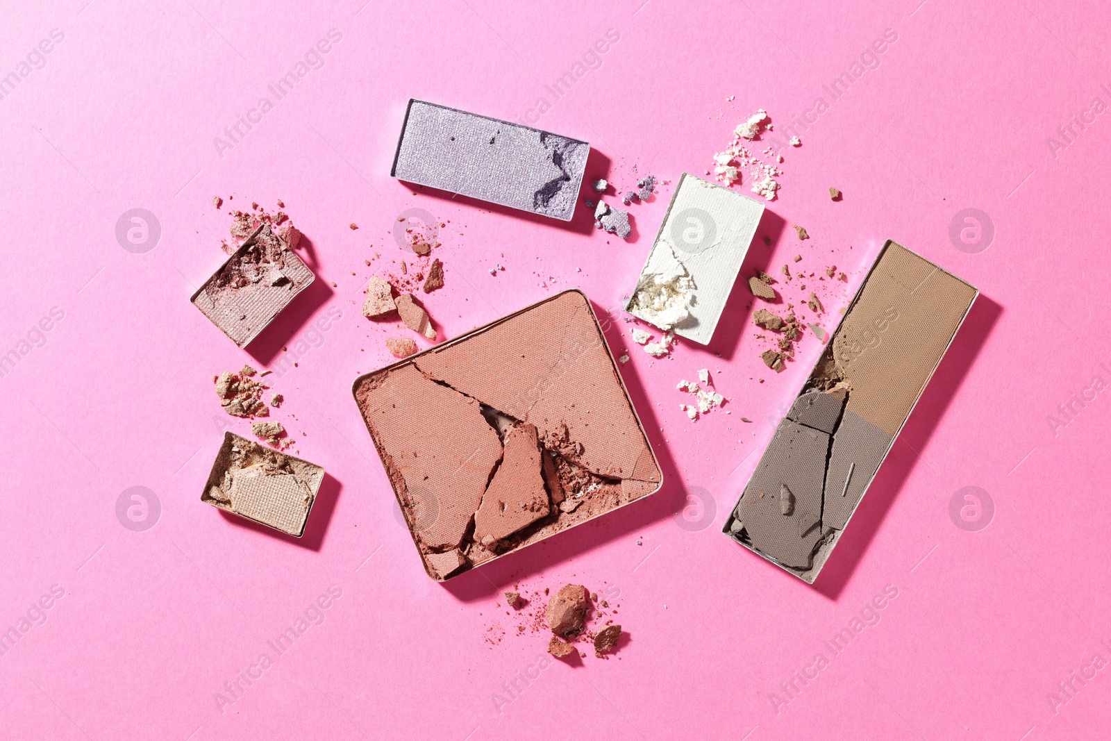 Beautiful eyeshadow refill pans on pink background, flat lay Photo of Beautiful eyeshadow refill pans on pink background, flat lay