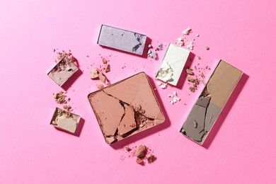 Photo of Beautiful eyeshadow refill pans on pink background, flat lay