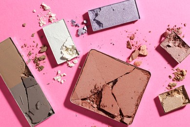 Photo of Beautiful eyeshadow refill pans on pink background, flat lay