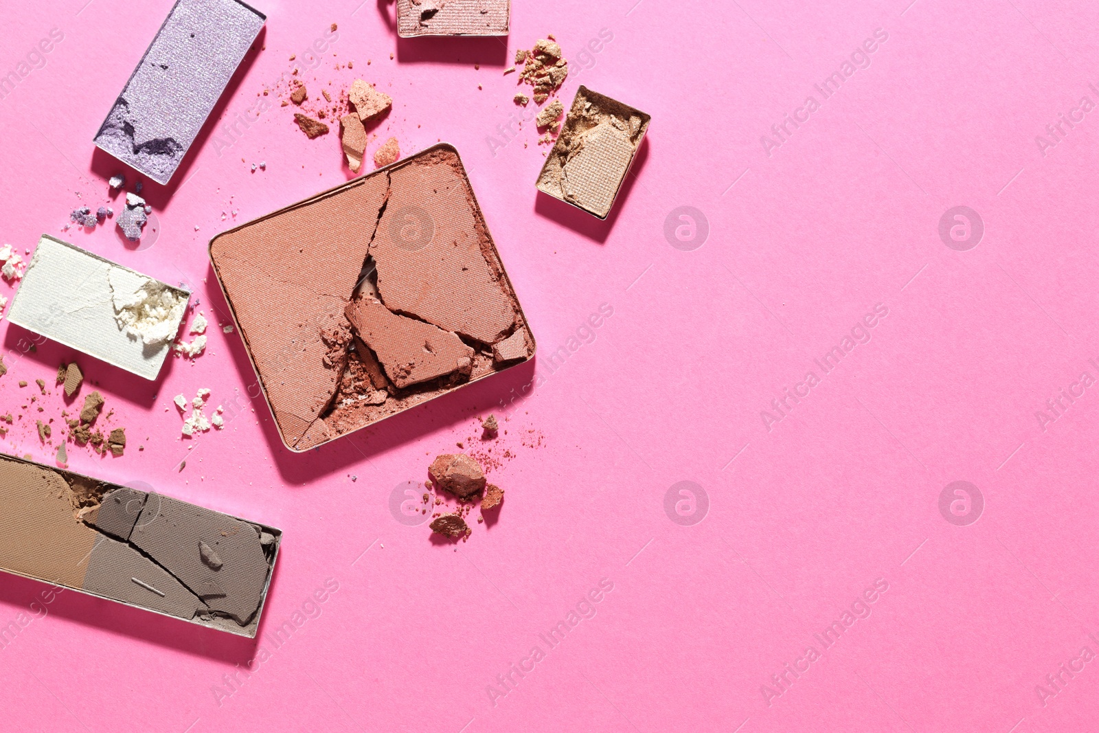 Beautiful eyeshadow refill pans on pink background, flat lay. Space for text Photo of Beautiful eyeshadow refill pans on pink background, flat lay. Space for text