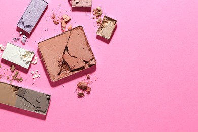 Photo of Beautiful eyeshadow refill pans on pink background, flat lay. Space for text