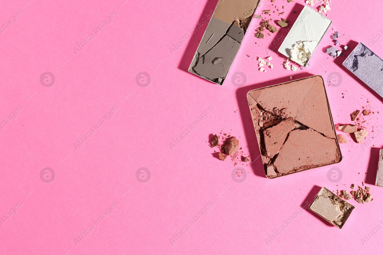 Beautiful eyeshadow refill pans on pink background, flat lay. Space for text Photo of Beautiful eyeshadow refill pans on pink background, flat lay. Space for text