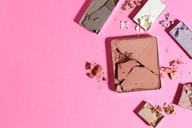 Photo of Beautiful eyeshadow refill pans on pink background, flat lay. Space for text