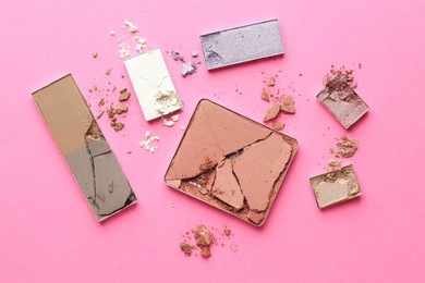 Photo of Beautiful eyeshadow refill pans on pink background, flat lay