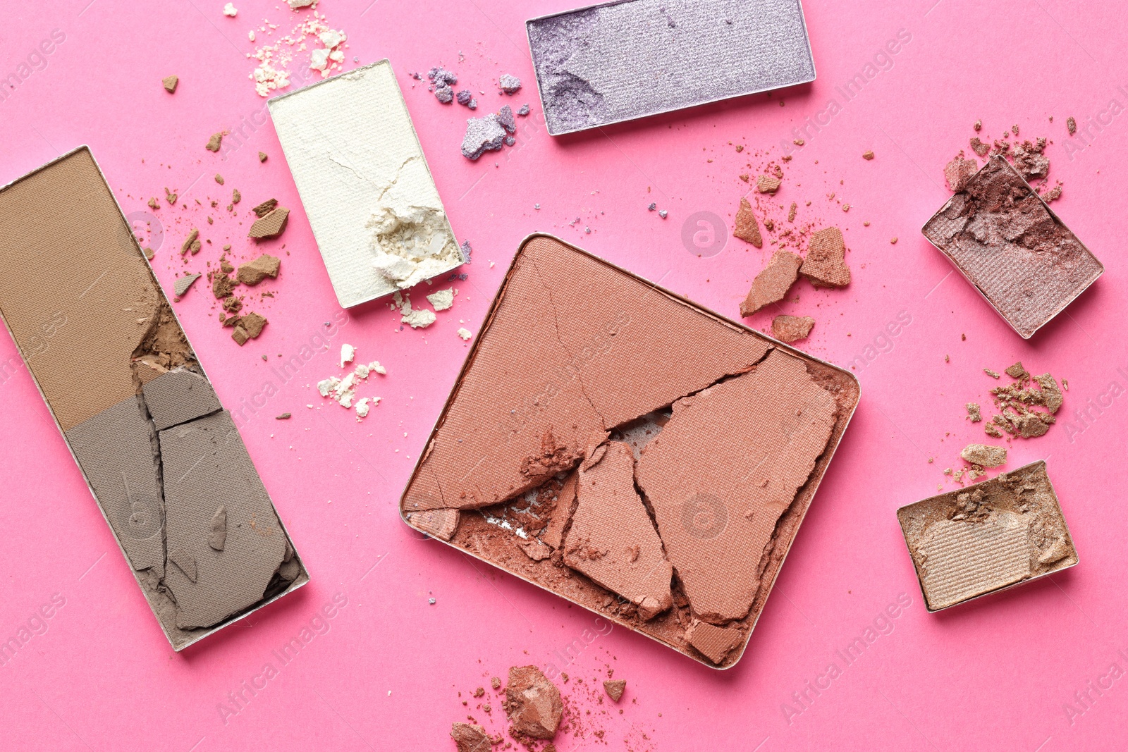 Beautiful eyeshadow refill pans on pink background, flat lay Photo of Beautiful eyeshadow refill pans on pink background, flat lay