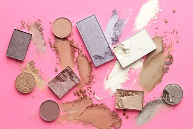 Photo of Beautiful eyeshadow refill pans on pink background, flat lay