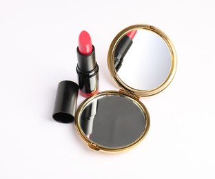 Photo of Open pocket mirror and lipstick isolated on white, above view