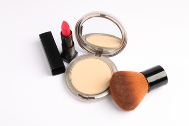 Photo of Open face powder with mirror, brush and lipstick isolated on white, above view