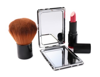 Photo of Open pocket mirror, brush and lipstick isolated on white