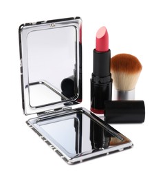 Photo of Open pocket mirror, brush and lipstick isolated on white
