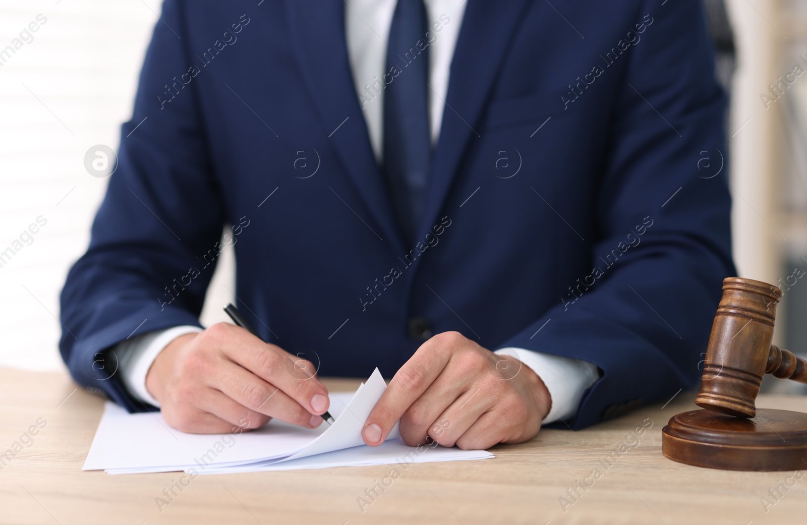 Judge working and gavel at desk indoors, closeup Photo of Judge working and gavel at desk indoors, closeup