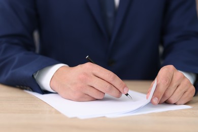 Photo of Judge working at wooden desk indoors, closeup