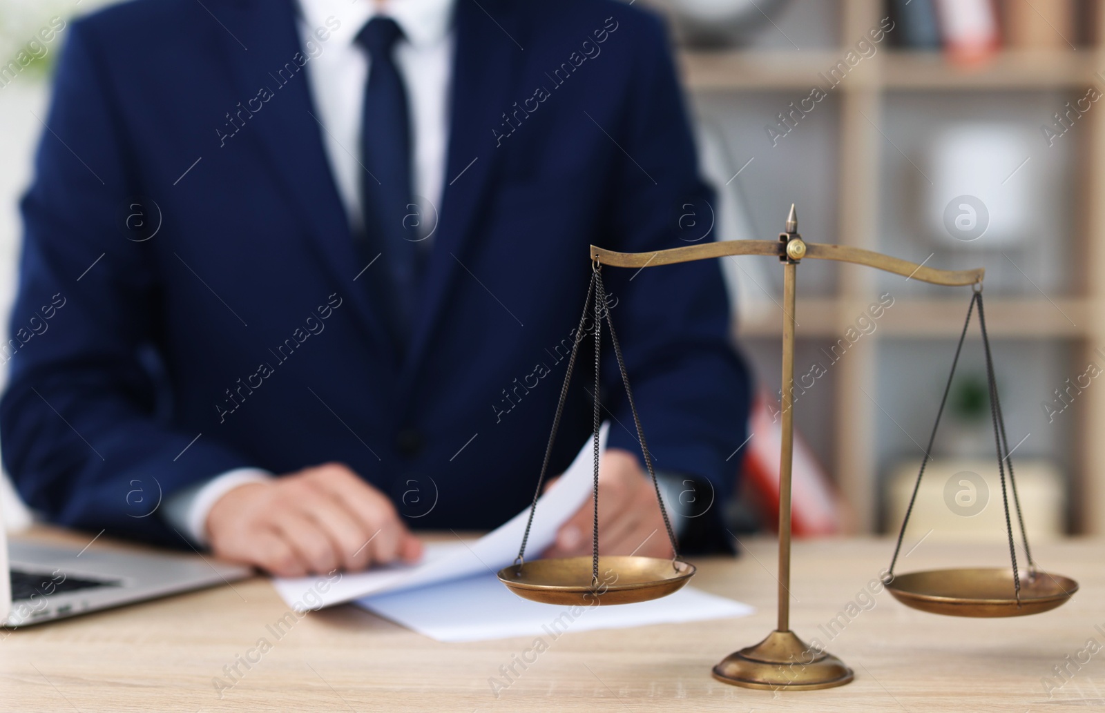 Judge working and scales on desk indoors, selective focus Photo of Judge working and scales on desk indoors, selective focus