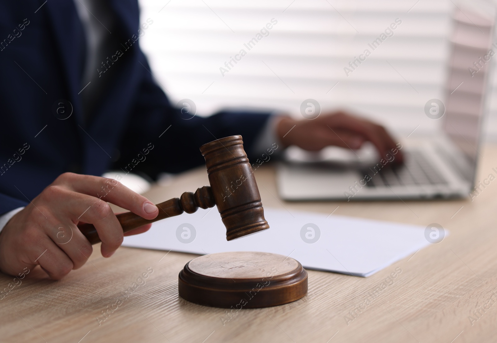 Judge with gavel working at desk indoors, closeup Photo of Judge with gavel working at desk indoors, closeup