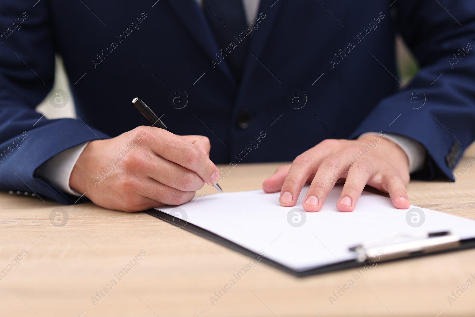 Judge working at wooden desk indoors, closeup Photo of Judge working at wooden desk indoors, closeup